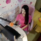 Online hostess Xianggong pouts as she gives a live broadcast in her bedroom